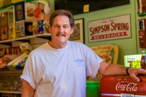 Better Times Emporium owner Steve Davoli poses with his prized antique vintage Coca-Cola dispenser. (Photo by Leah Astore)
